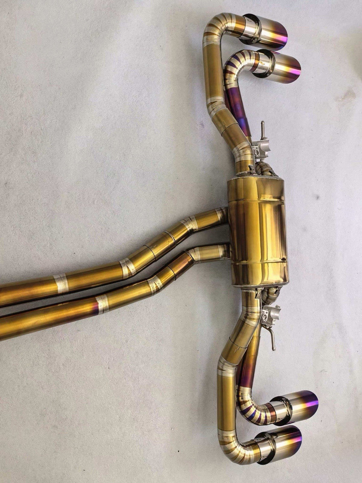 Titanium valved sport catback exhaust for 2018-2024 Lamborghini Urus, by JackSpania Racing, with polished finish and integrated exhaust tips.
