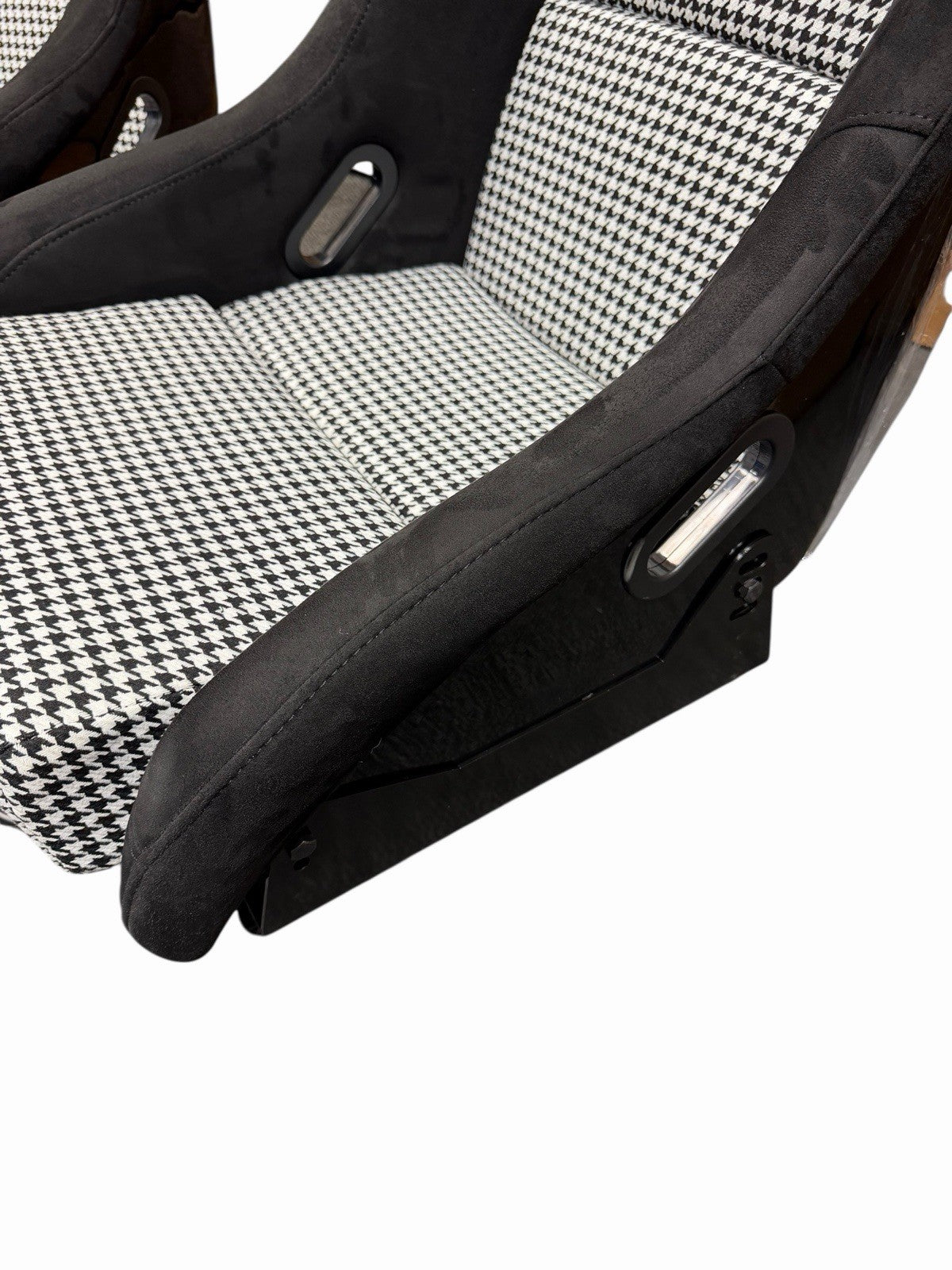 JackSpania Racing lightweight fixed bucket seat with suede upholstery, mounted with rails and sliders for interior racing car setup.