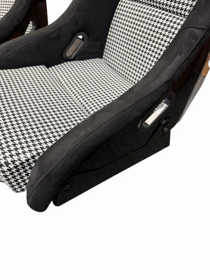 JackSpania Racing lightweight fixed bucket seat with suede upholstery, mounted with rails and sliders for interior racing car setup.