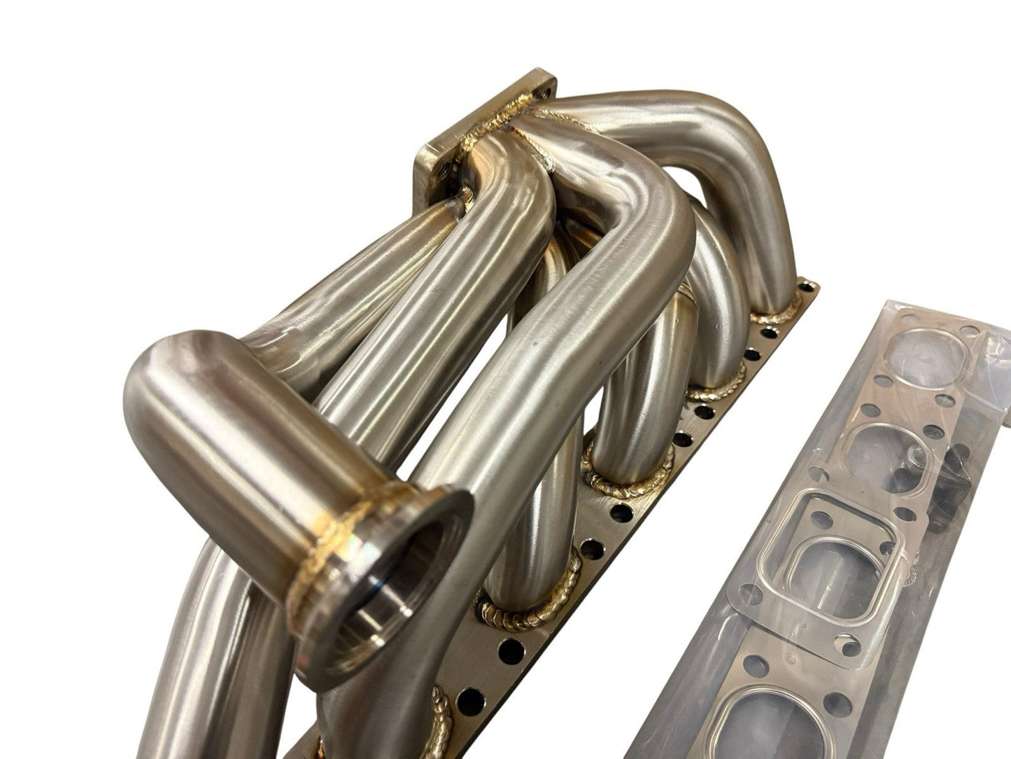 JackSpania Racing BMW E30 E34 M50 M52 M54 S50 tubular top mount turbo manifold with T3 flange and 44mm wastegate opening.