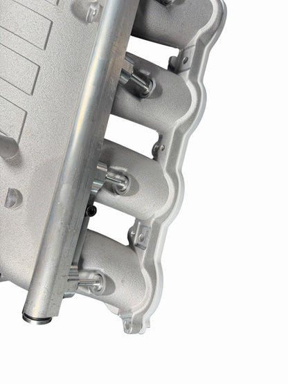 Cast aluminum charge cooler intake manifold for BMW G87 M2, G80 M3, G82 M4 S58 engine by JackSpania Racing, showing detailed engine part.