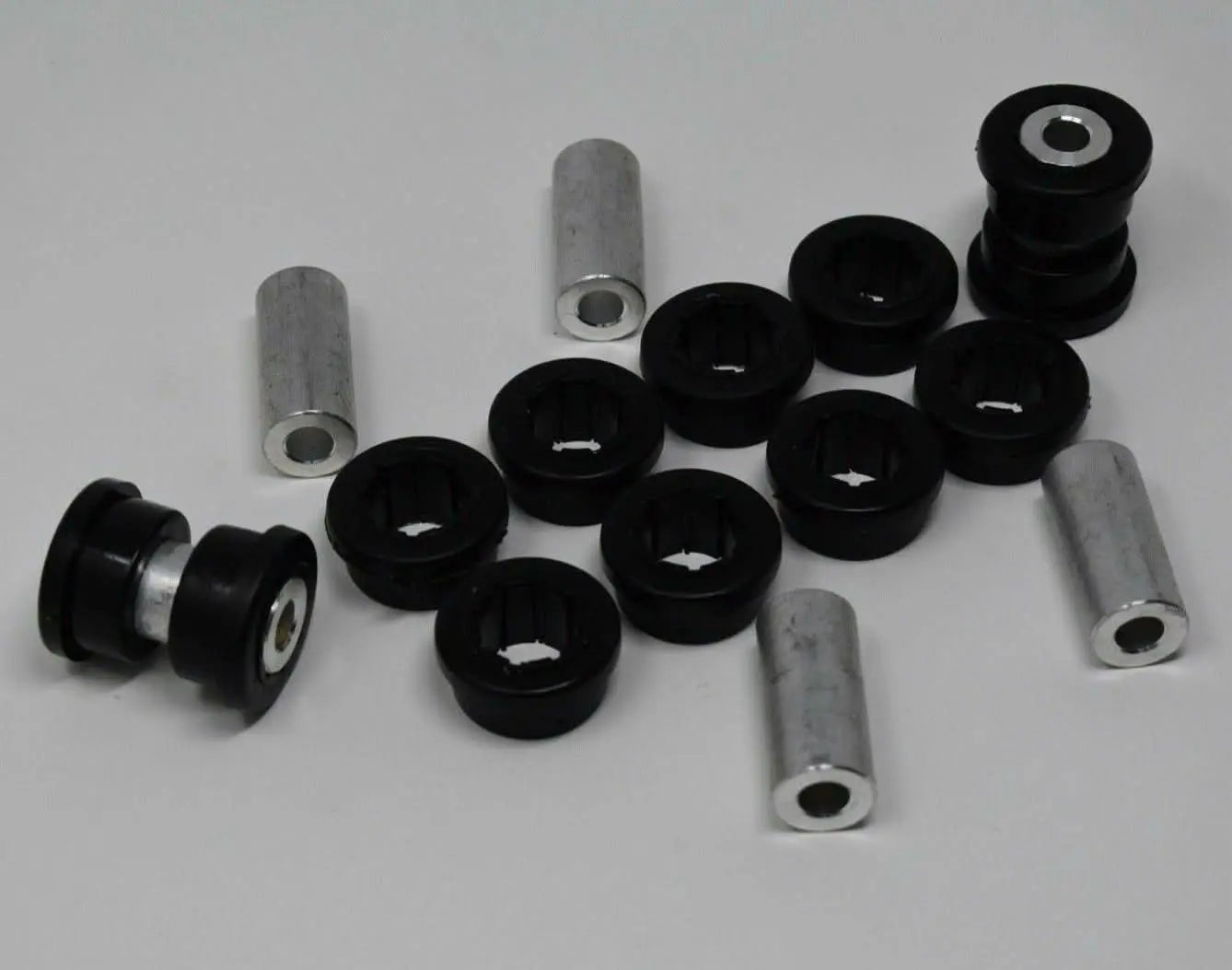 Jack Spania Racing replacement bushings with inserts for Skunk2 EG EK DC lower control arms and rear camber suspension parts.