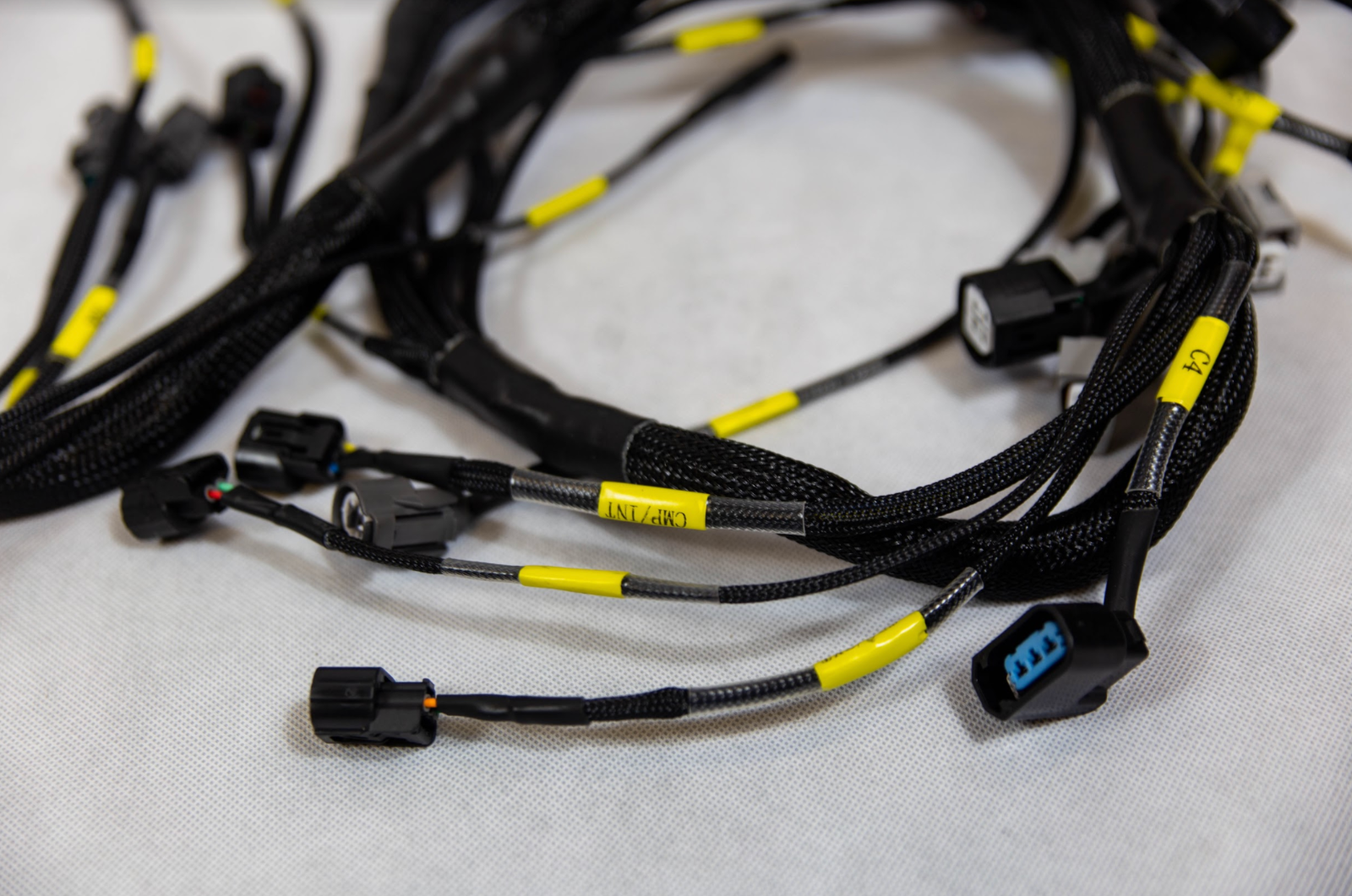 Jack Spania Racing K20 K24 K-Series tucked engine harness for Honda Acura K-Swap, shown with wiring and connectors.