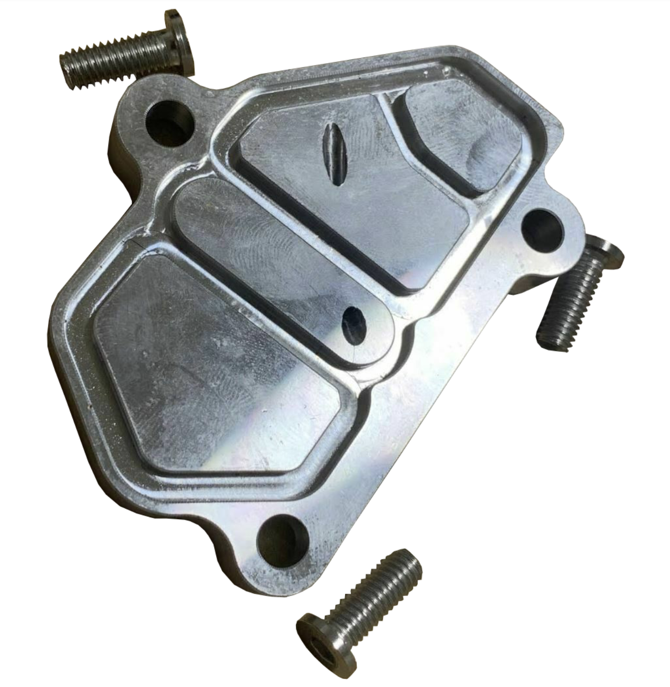 Vtec solenoid block off plate for Honda Acura B-Series B16 B18 engines, by Jack Spania Racing, shown on engine part.